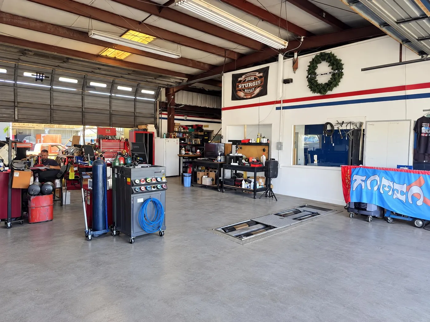 Workshop with fluid service carts and stacked tires