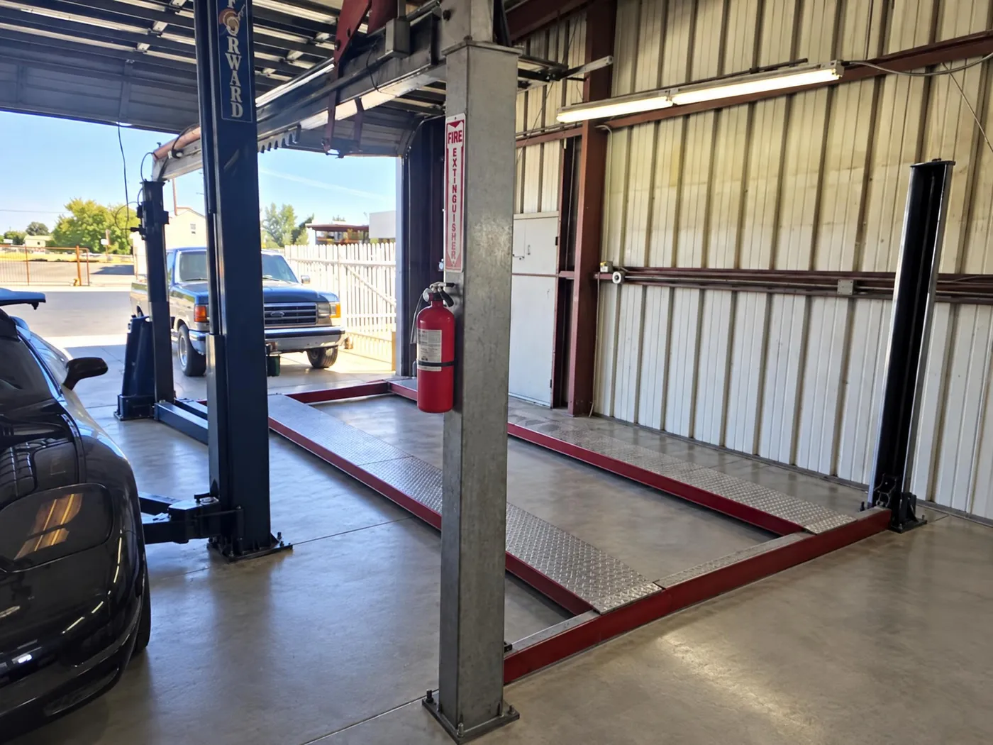 Clean service bay with two-post lifts