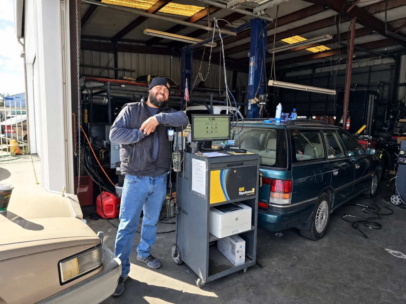 Technician running an emissions test on an SUV